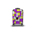 A hard-shell kids spinner suitcase with a colorful geometric cat face design in purple, yellow, white, and gray, featuring the brand name 'skismic' on the front.