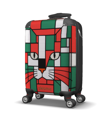A hard-shell suitcase with a colorful geometric cat face print in red, green, white, and black, featuring four spinner wheels and a telescoping handle.