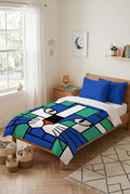 A kids duvet cover  featuring a stylized cat face in a stained-glass mosaic pattern with blue, green, white, with plain royal blue pillows