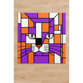 A square kids play mat featuring a cat face in a geometric stained-glass style, with purple, orange, white, and black blocks, displayed against a light wood floor.