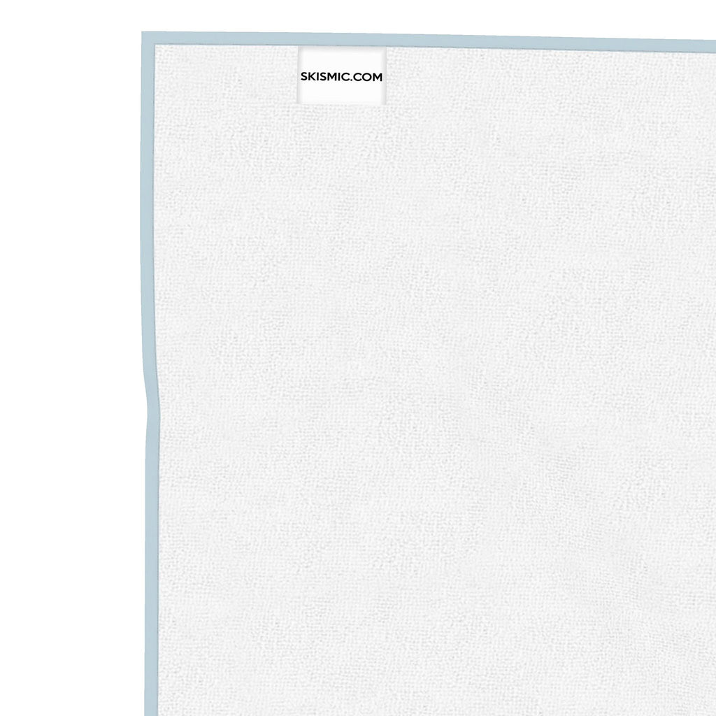A close-up of a white textured board with a light pink border, showing a small SKISMIC.COM label at the top, set against a solid white background.