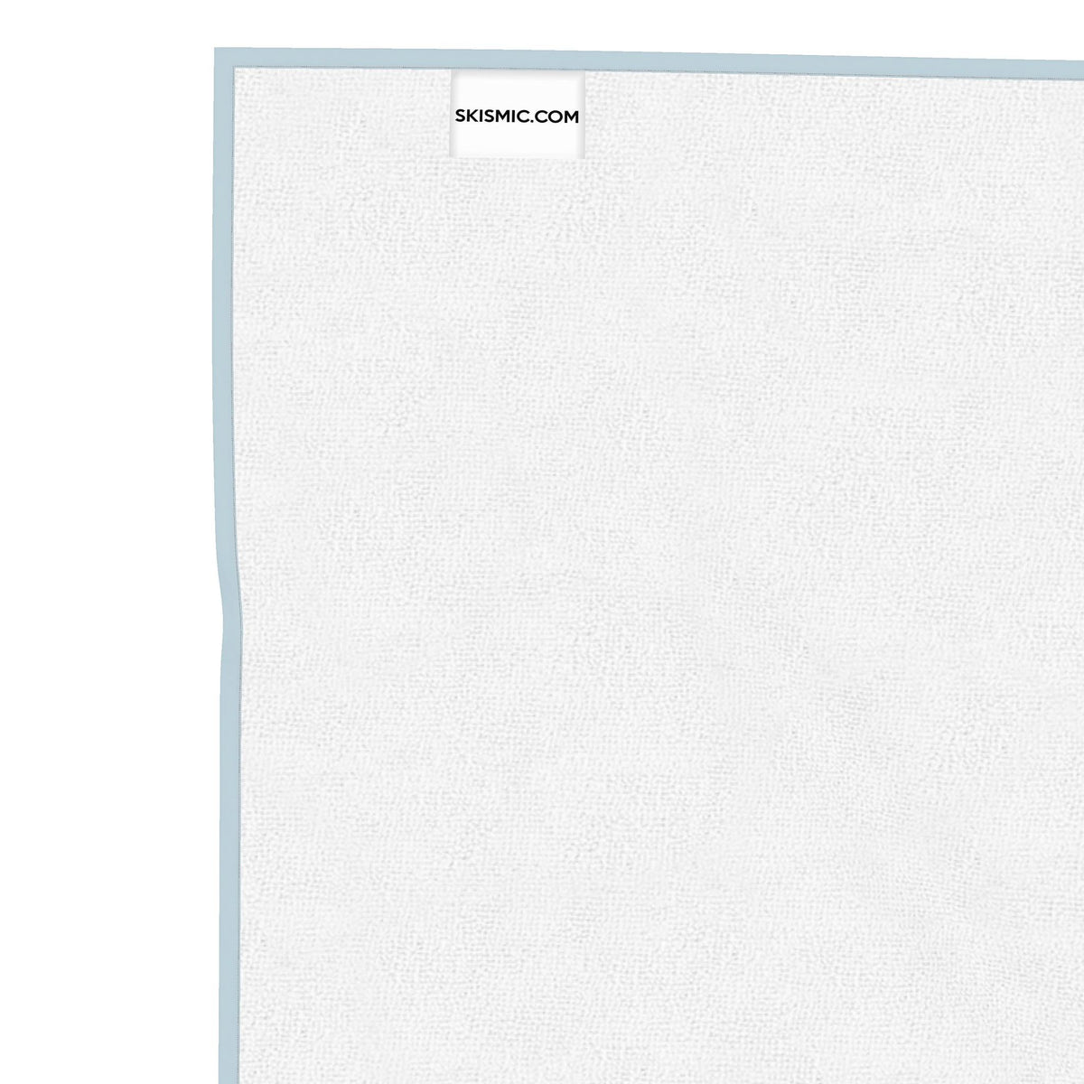 A close-up of a white textured board with a light pink border, showing a small SKISMIC.COM label at the top, set against a solid white background.
